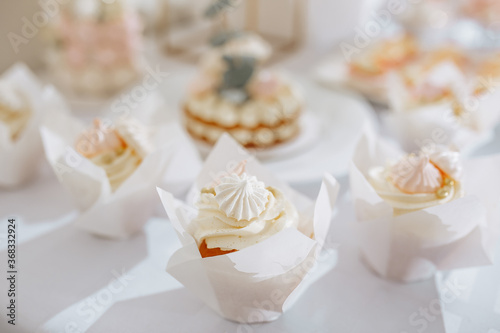 Candy bar at the banquet. Wedding table with sweets, cake, pastries, muffins, sugar treats. Event in the restaurant