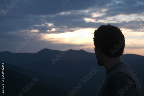 silhouette of man looking at sunrise
