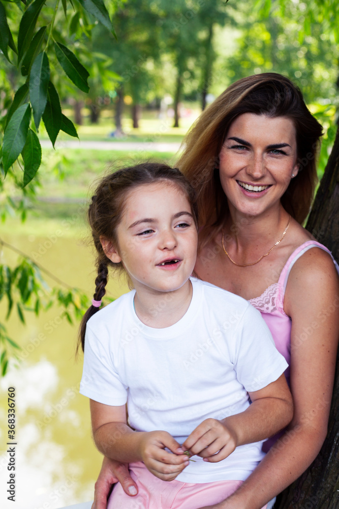 young pretty mother walking with little cute daughter outside in green park, lifestyle poeple concept young pretty mother walking with little cute daughter outside in green park, lifestyle poeple concept