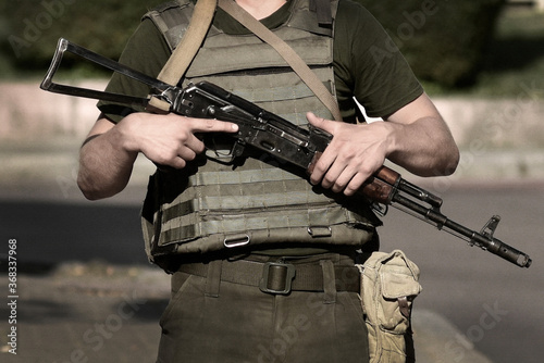 Soldier Military with weapon. Armed forces, troops, army. Soldier with Kalashnikov assault rifle (AK-74)
