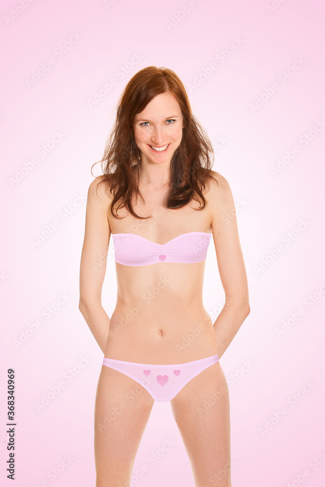 Highly attractive young woman wearing pink bra and panties, closeup portrait isolated in front of pink background Highly attractive young woman wearing pink bra and panties, closeup portrait isolated in front of pink background