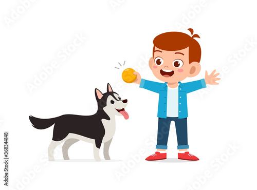 happy cute little kid boy girl play with pet dog