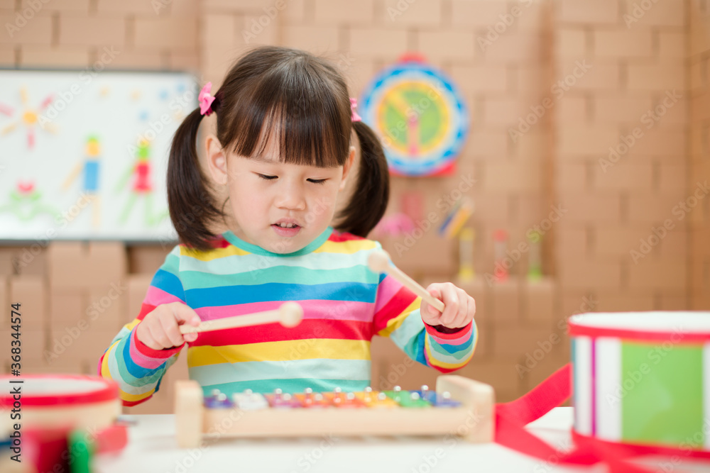 young girl play xylophone at home for homeschooling young girl play xylophone at home for homeschooling