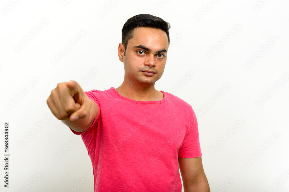 Portrait of young handsome Indian man against white background Portrait of young handsome Indian man against white background