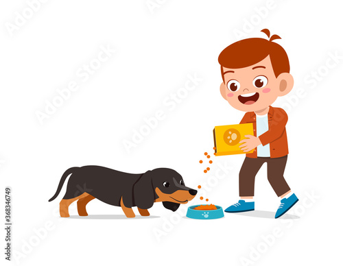 happy cute little kid boy girl play with pet dog