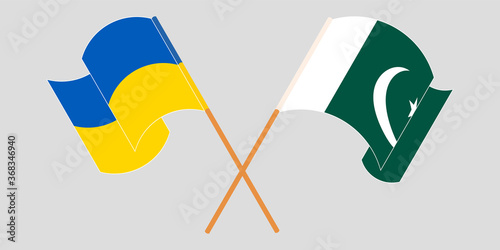 Crossed and waving flags of Pakistan and the Ukraine