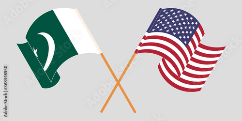 Crossed and waving flags of Pakistan and the USA