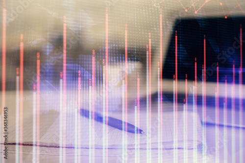 Double exposure of financial graph drawings and desk with open notebook background. Concept of forex market © peshkova