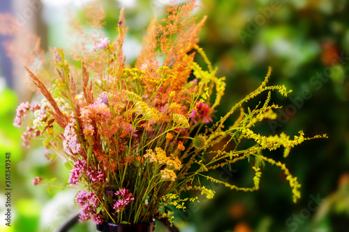 Bouquet of wild flowers in vase in a garden