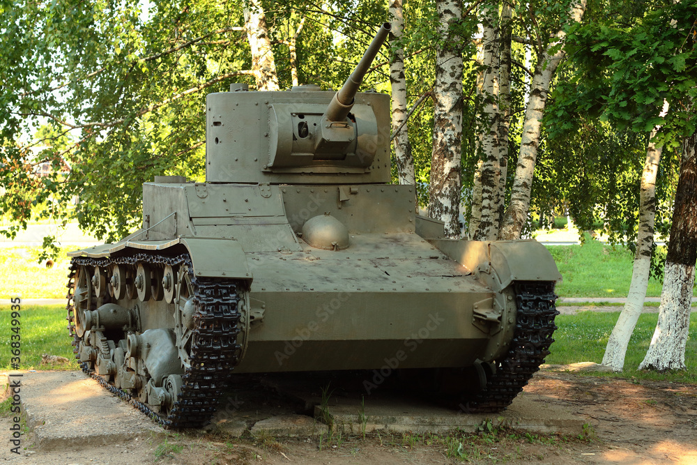 Old tank under the trees, participated in the 2nd world war. Old tank under the trees, participated in the 2nd world war.