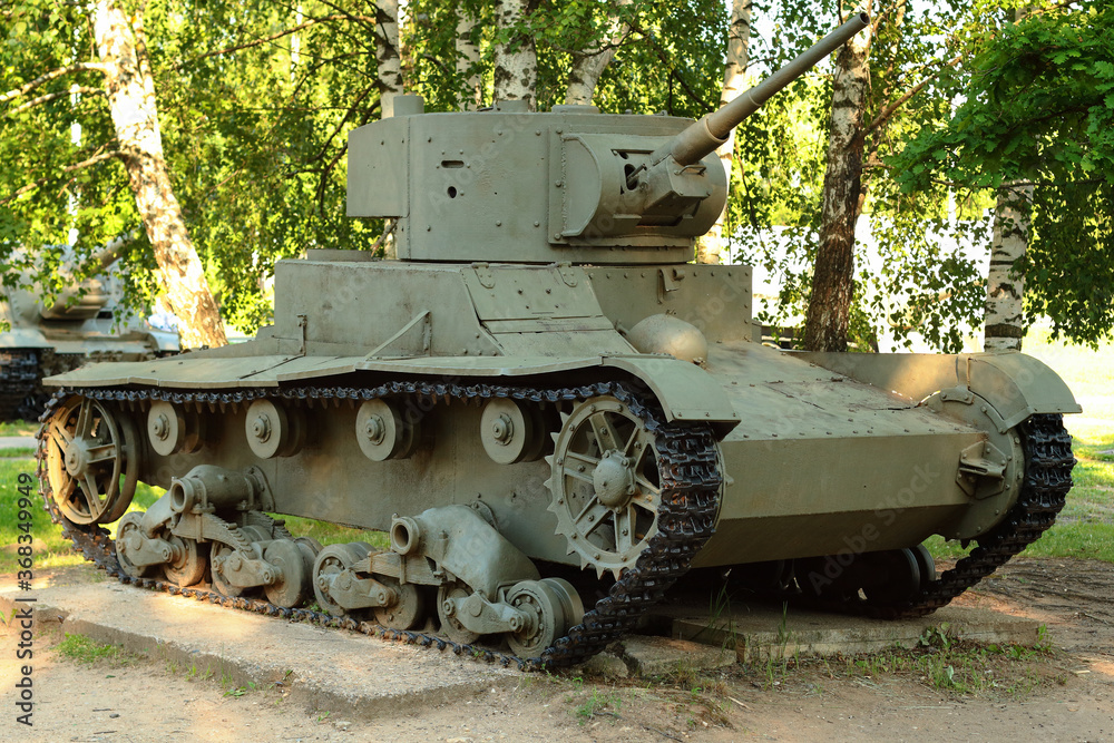 Old tank under the trees, participated in the 2nd world war.