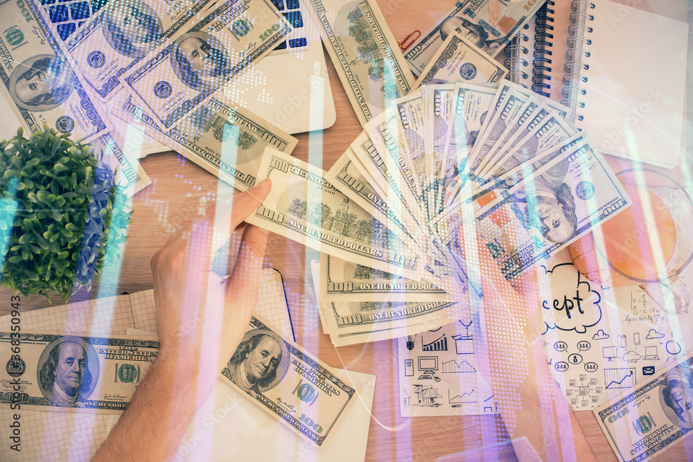 Multi exposure of financial graph drawing hologram and USA dollars bills and man hands. Analysis concept. Multi exposure of financial graph drawing hologram and USA dollars bills and man hands. Analysis concept.