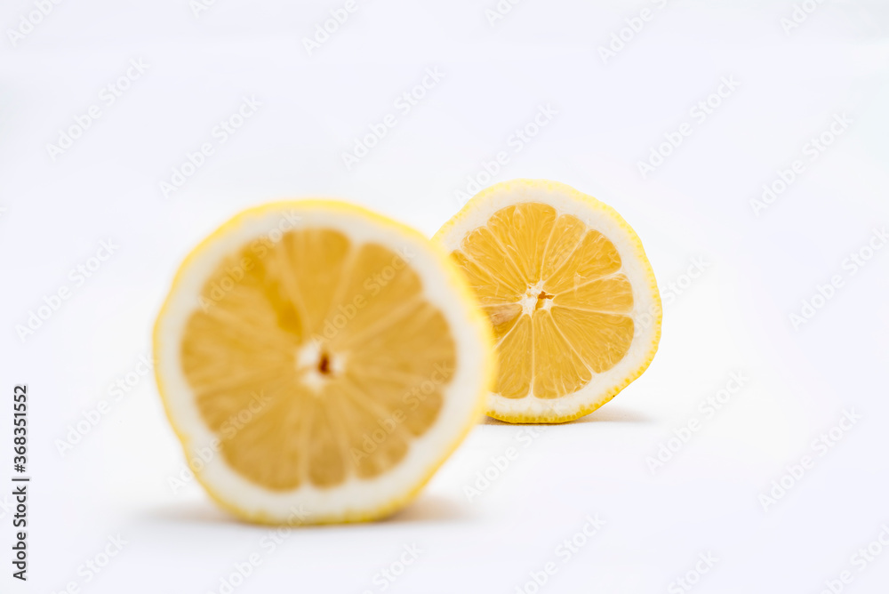 Fresh and juicy lemons cut on white background