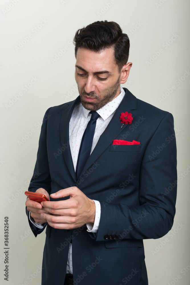Portrait of handsome bearded businessman using phone Portrait of handsome bearded businessman using phone