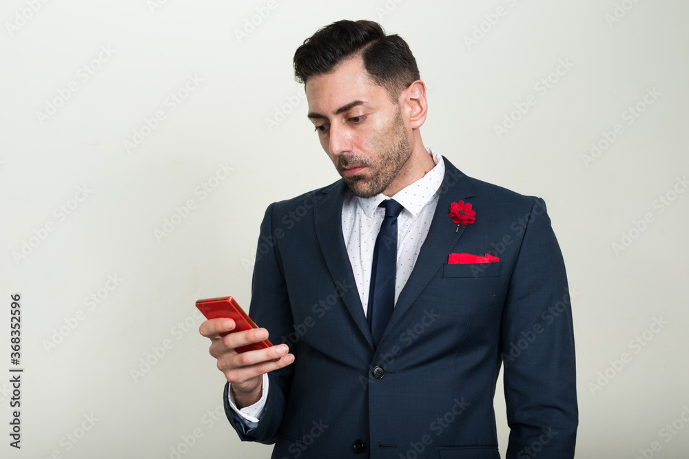 Portrait of handsome bearded businessman using phone Portrait of handsome bearded businessman using phone