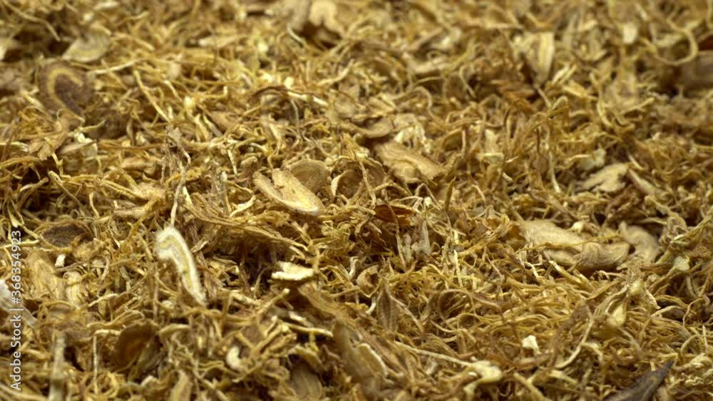 Rolling tobacco in rotation..Fine cut loose tobacco for self-made cigarettes..Close up. Rotation. Rolling tobacco in rotation..Fine cut loose tobacco for self-made cigarettes..Close up. Rotation.