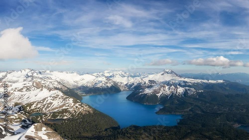 Cinemagraph Continuous Loop Animation. Aerial Panoramic View of Garibaldi surrounded by Canadian Mountain Landscape during a sunny and cloudy day. Taken near Squamish, North of Vancouver, BC, Canada.