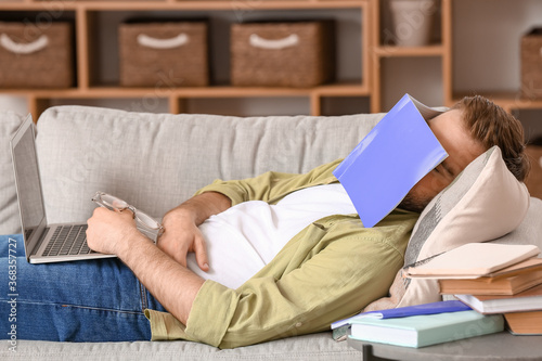 Tired male student sleeping...
