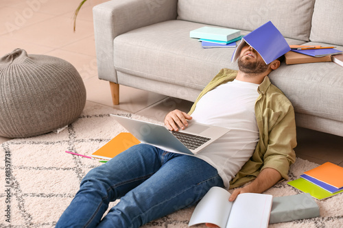 Tired male student sleeping...