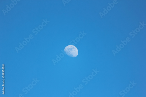 Daytime moon and blue sky