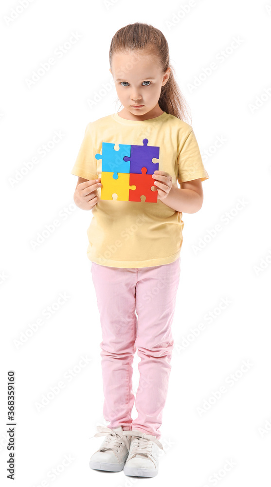 Little girl with autistic disorder and puzzle pieces on white background Little girl with autistic disorder and puzzle pieces on white background