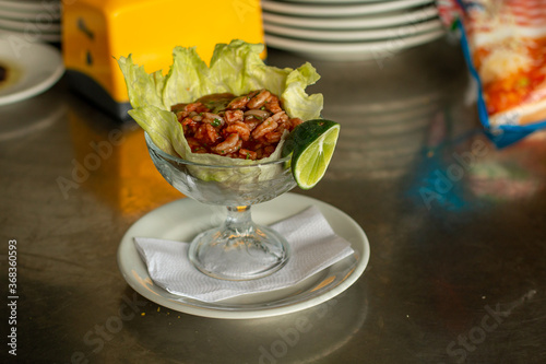 shrimp ceviche with lemon, lettuce and red spice sauce