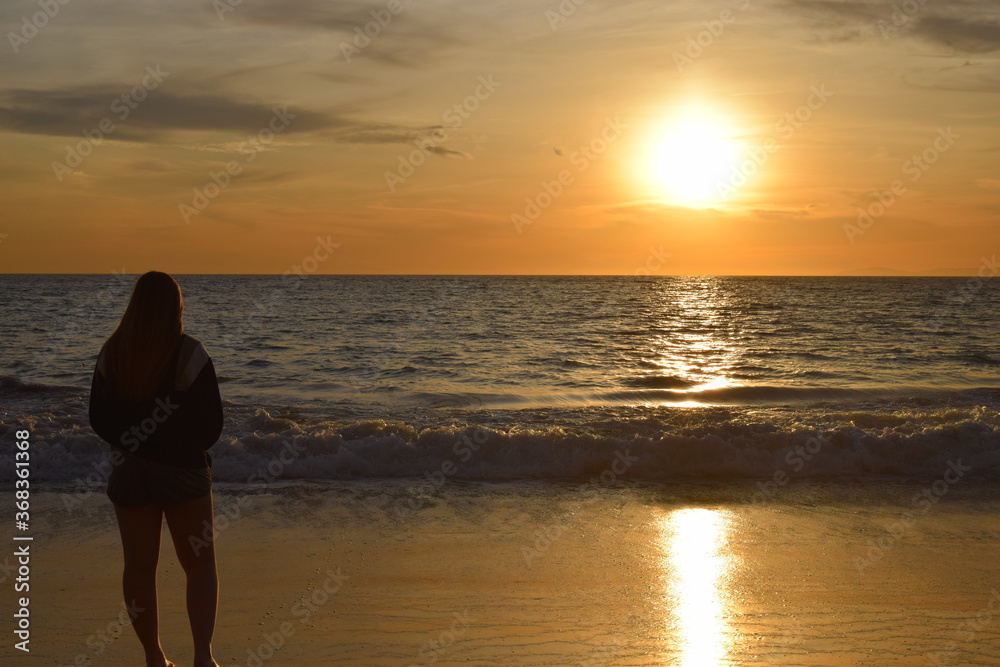 woman on the beach at sunset