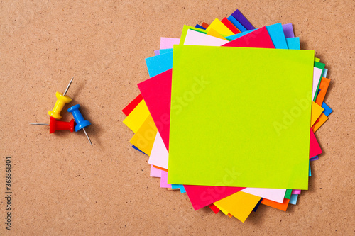 Colorful memo pads on the cork board 