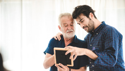senior bearded father and adult son talking at home, 2 moustache hipster man and family concept