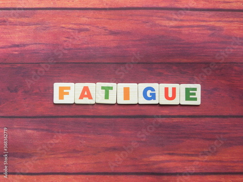 Word Fatigue on wood background