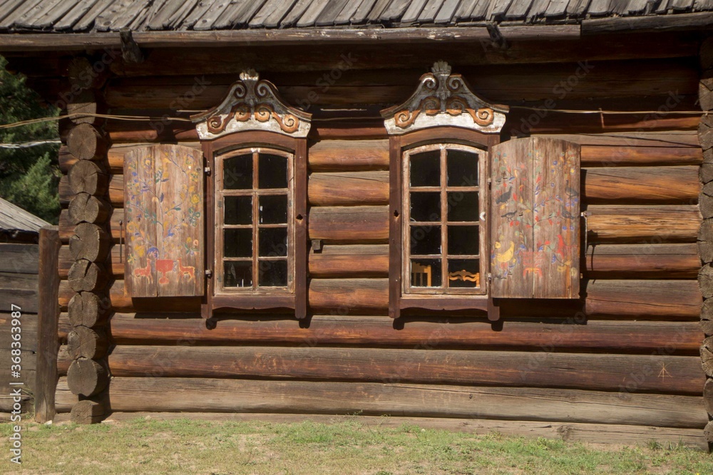 windows with shutters of a strin wooden house in the Russian style windows with shutters of a strin wooden house in the Russian style