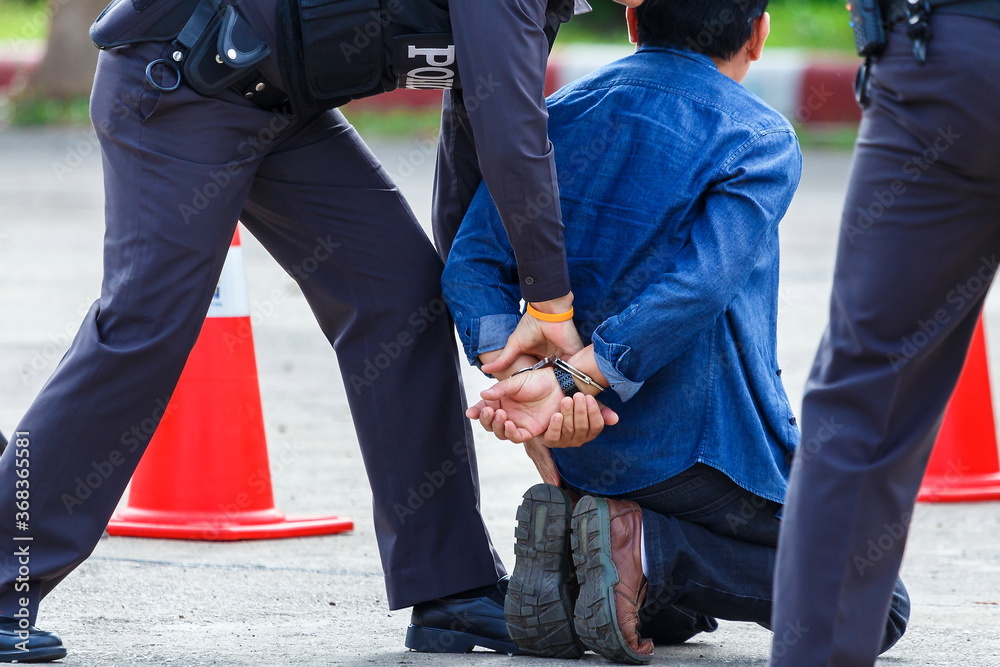 police helped to catch the guilty and lock the handcuffs,arrested. police helped to catch the guilty and lock the handcuffs,arrested.