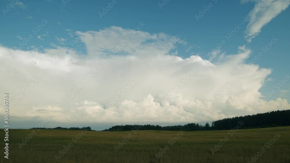 Huge rain clouds cumulus stratocumulus time lapse over countryside fields Huge rain clouds cumulus stratocumulus time lapse over countryside fields