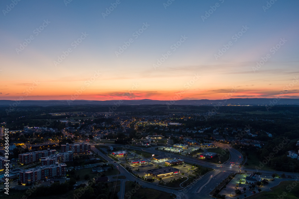 Aerial view of Urbana, Frederick County, Maryland at dusk. Catoctin Mountain, part of the Blue Ridge Mountains, is on the horizon.