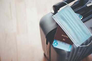 Passport and mask On luggage, concept tourism planning and new normal travel