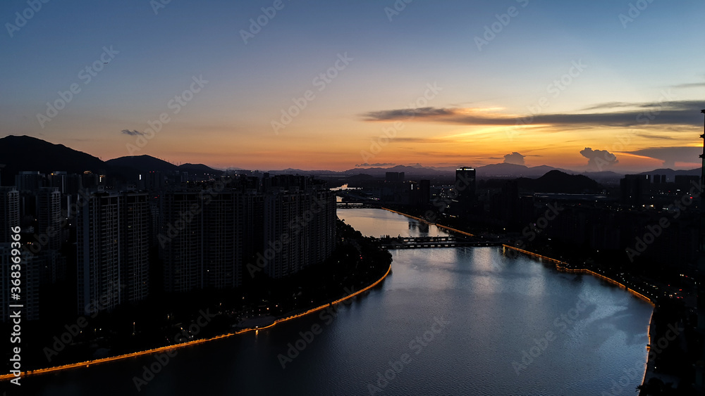 Beautiful sunset cityscape of skyscrapers and river