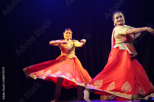 Two beautiful kathak dancers dancing ad frozen in time