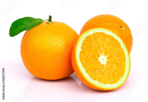 orange fruit with green leaf isolated on white