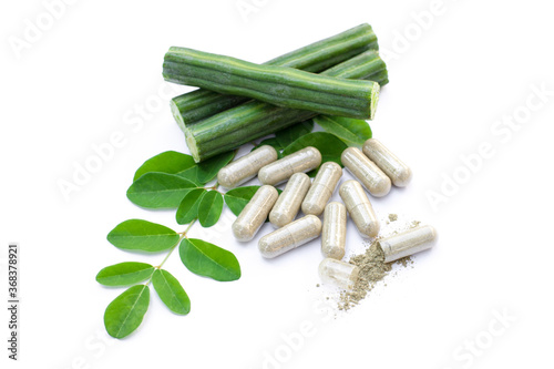 Moringa Oleifera ( Horse radish or Drumstick ) with green leaves and capsules isolated on white background. Herbal medicine plant conceptual. photo