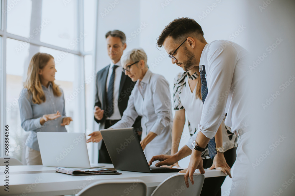Senior businesswoman working together with young business people in office Senior businesswoman working together with young business people in office