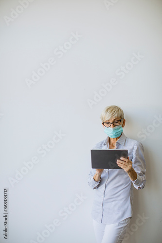 Mature businesswoman using ...