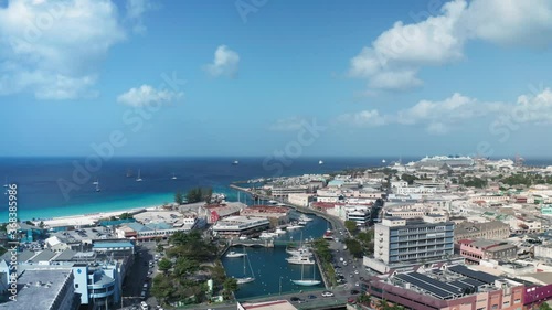 An air drone moves over Bridgetown, Barbados on the sunny day. On the horizon the sea turns into the sky