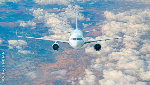 White passenger airplane in the clouds  - Travel by air transport