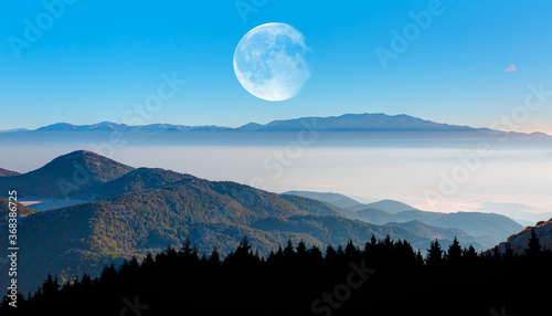 Misty view of the blue mountain range with full moon - Beautiful landscape with cascade blue mountains at the morning "Elements of this image furnished by NASA"