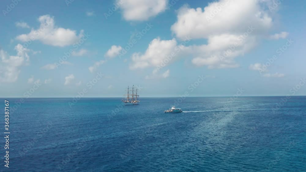 Aerial drone approaching a white ship and a boat in the sea near Bridgetown, Barbados Aerial drone approaching a white ship and a boat in the sea near Bridgetown, Barbados