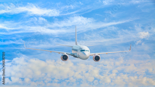 White passenger airplane in the clouds - Travel by air transport