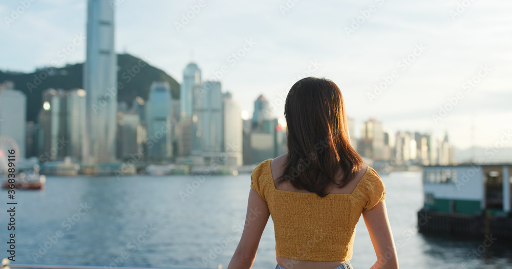 Woman look at the city view in sunset time