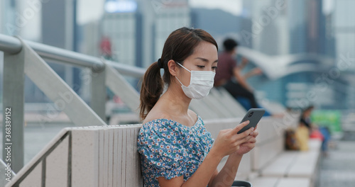 Photography Woman wear face mask and use of mobile phone in city