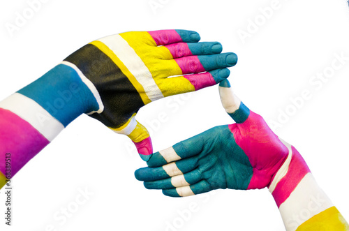 Pair of creative painted hands, colorized with the CMYK color model. Conceptual idea of bold body art. Isolated on white.