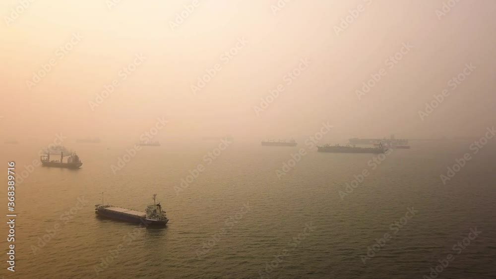 Aerial shot of hazy sunrise vessel anchorage Singapore Aerial shot of hazy sunrise vessel anchorage Singapore